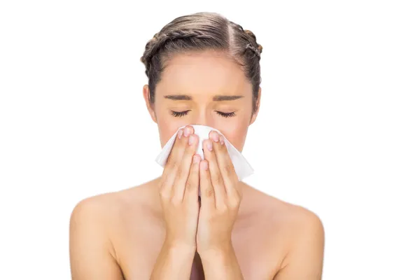 Sick young model blowing her nose — Stock Photo, Image