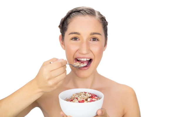 Cheerful healthy model eating cereals — Stock Photo, Image