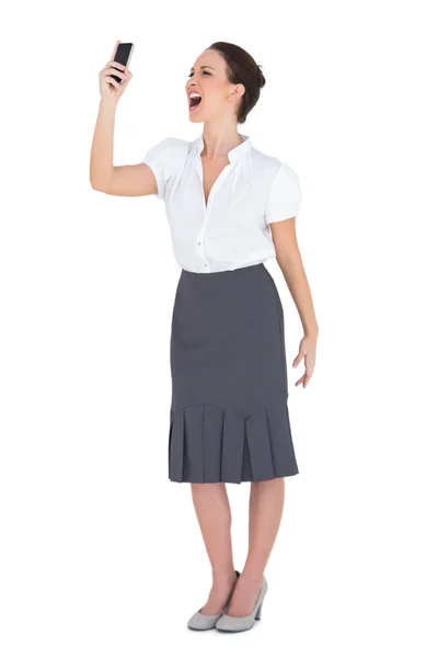 Angry businesswoman yelling at her phone — Stock Photo, Image