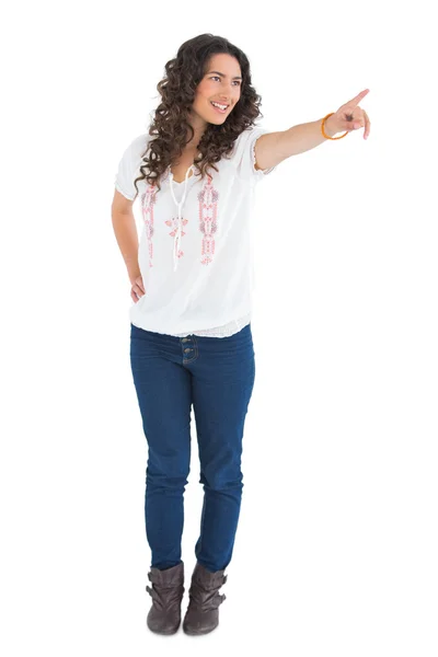 Cheerful attractive brunette wearing casual clothes pointing — Stock Photo, Image