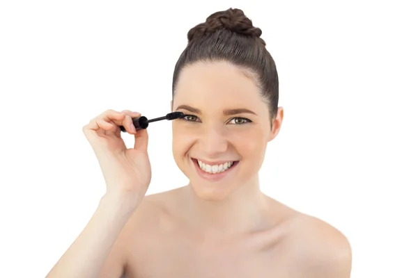 Cheerful pretty model applying mascara — Stock Photo, Image