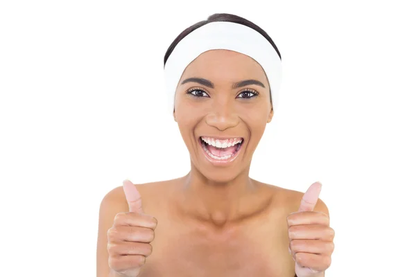 Smiling gorgeous model wearing headband giving thumbs up to camera — Stock Photo, Image