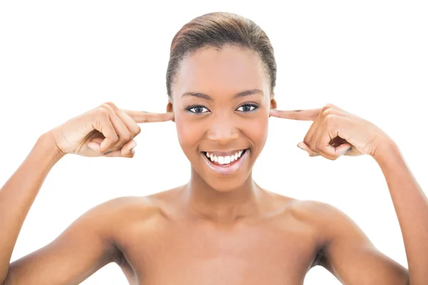 Smiling nude beauty covering her ears — Stock Photo, Image