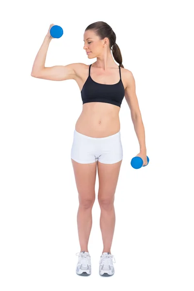 Relaxed fit woman exercising with dumbbells — Stock Photo, Image