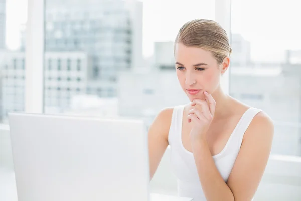 Denken blonde haar laptop gebruikt — Stockfoto