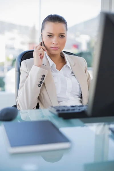 Serious sophisticated businesswoman on the phone — Stock Photo, Image