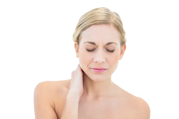 Frowning young blonde woman posing with closed eyes — Stock Photo, Image