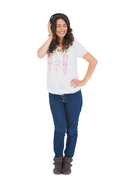 Cheerful pretty brunette with headphones posing