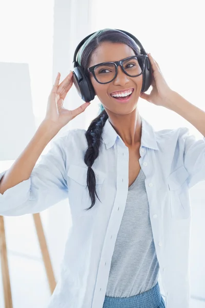 Happy attractive artist listening to music — Stock Photo, Image