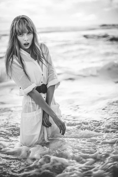 Beautiful model in shirt dress standing in the sea — Stock Photo, Image