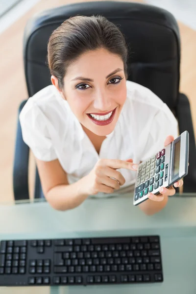 Happy accountant holding a calculator looking at camera — Stock Photo, Image