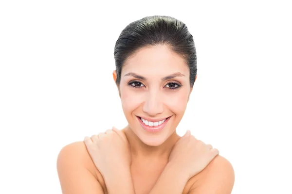 Smiling brunette with her hands on shoulders — Stock Photo, Image