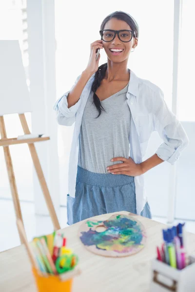 Cheerful pretty artist having a phone call — Stock Photo, Image