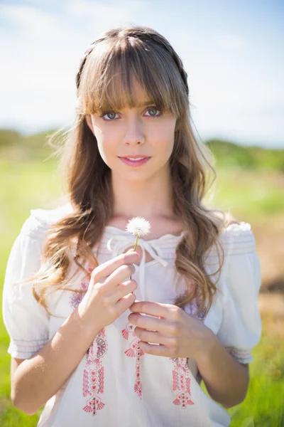 Peaceful young woman holding dandelion — Stock Photo, Image