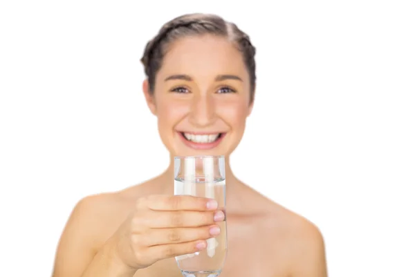Smiling young model holding glass of water — Stock Photo, Image