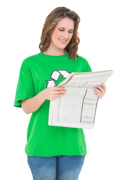 Smiling environmental activist reading newspaper — Stock Photo, Image