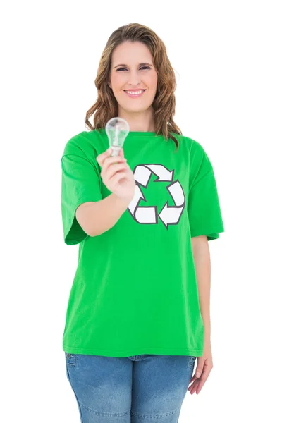 Smiling environmental activist holding light bulb — Stock Photo, Image