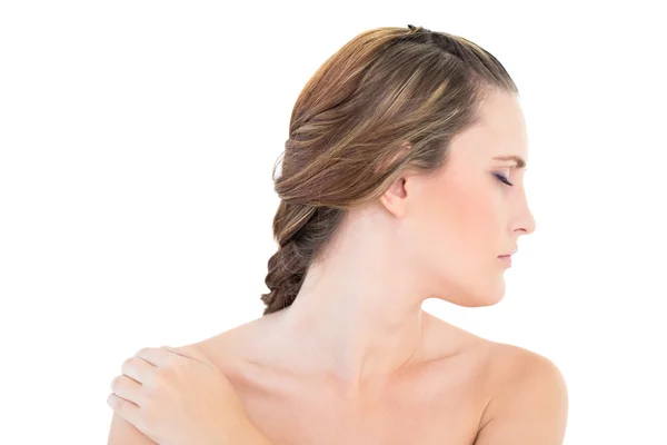 Woman looking aside with one hand on shoulder eyes closed — Stock Photo, Image