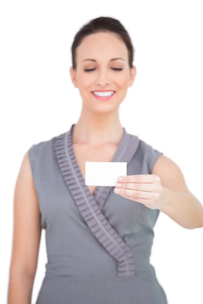 Smiling seductive model holding business card Stock Photo