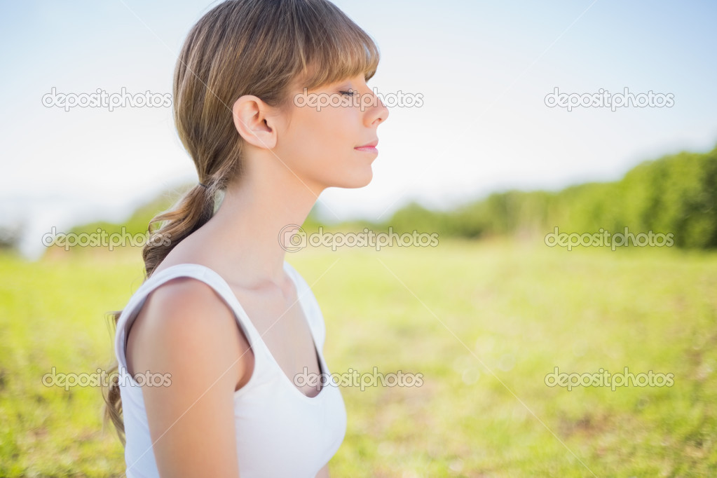 Peaceful young woman relaxing outside