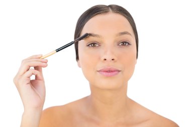 Woman brushing her eyebrow