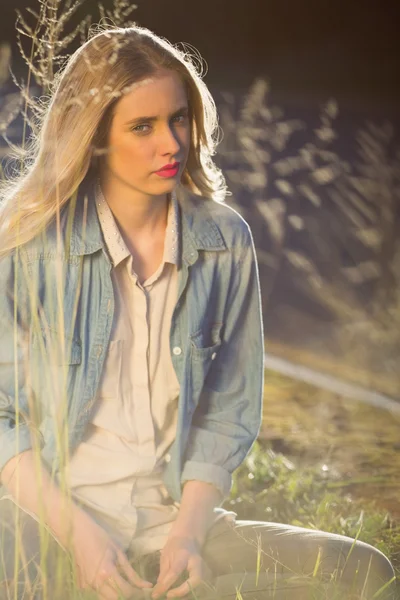 Calm model sitting in grass — Stock Photo, Image