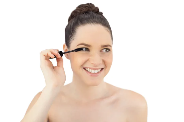 Smiling pretty model applying mascara — Stock Photo, Image