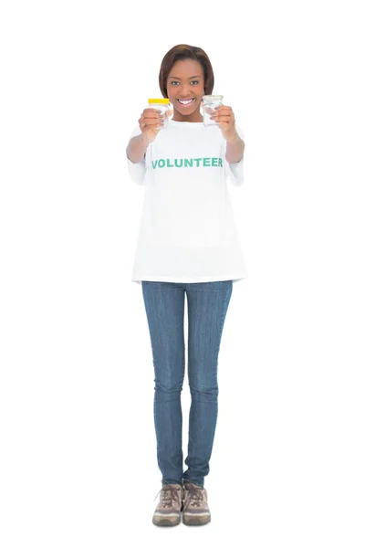 Happy volunteer woman holding glass jars — Stock Photo, Image