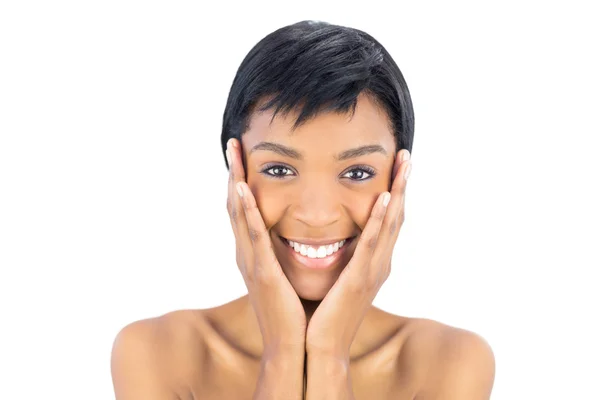 Joyful black haired woman posing holding her head — Stock Photo, Image