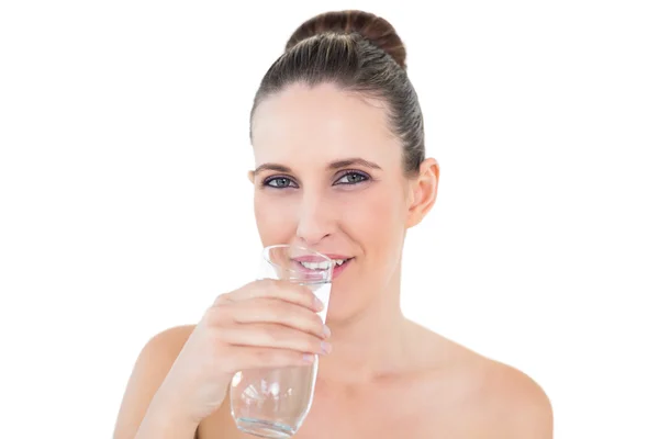 Woman drinking water looking at camera — Stock Photo, Image