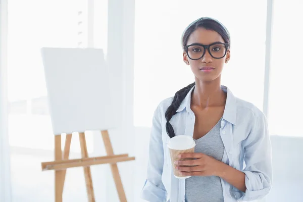 Cheerful attractive artist holding cup of coffee — Stock Photo, Image