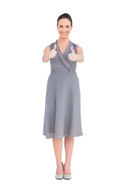 Elegant brunette in classy dress thumbs up — Stock Photo, Image