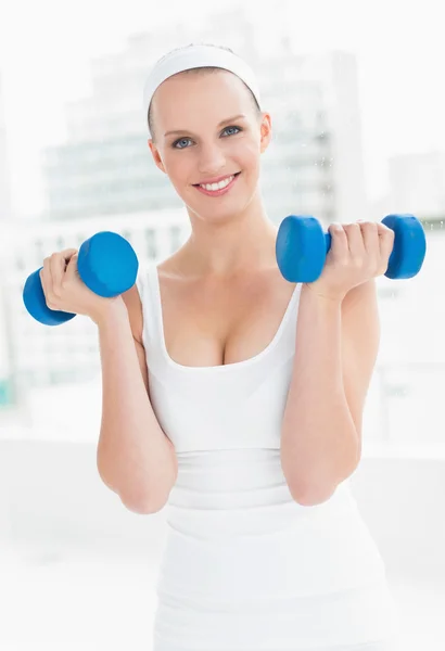 Motivated pretty sportswoman carrying dumbbells — Stock Photo, Image