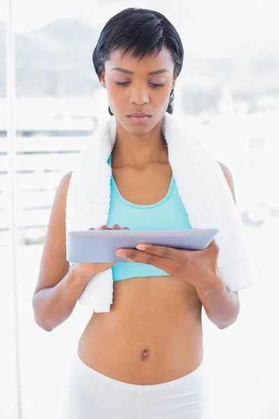 Stern black haired woman using a tablet pc — Stock Photo, Image