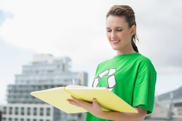 Smiling activist with recycling tshirt reading — Stock Photo, Image