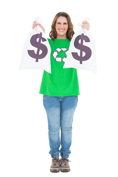 Smiling environmental activist holding money bags looking at camera — Stock Photo, Image