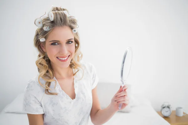 Smiling blonde wearing hair curlers — Stock Photo, Image