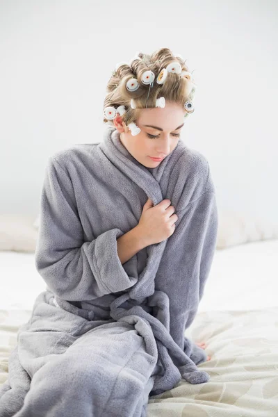 Cute relaxed blonde woman in hair curlers posing — Stock Photo, Image