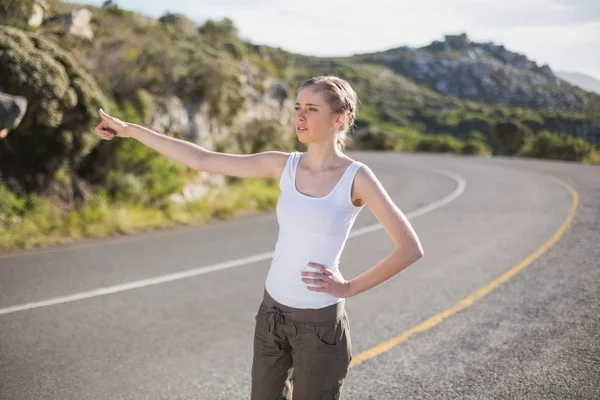 Stranded woman hitching a lift — Stock Photo, Image