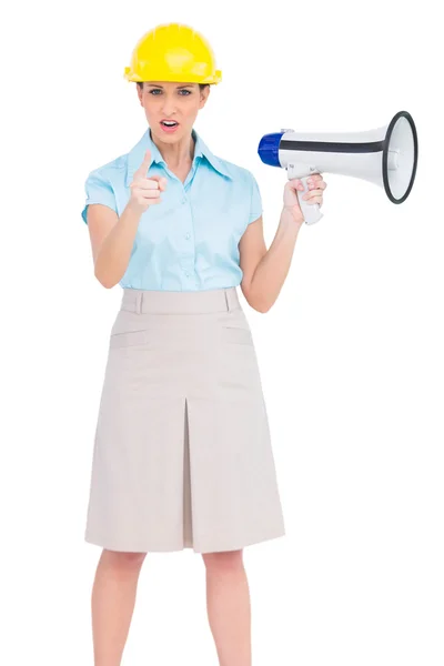 Stern attractive architect pointing at camera while holding megaphone — Stock Photo, Image