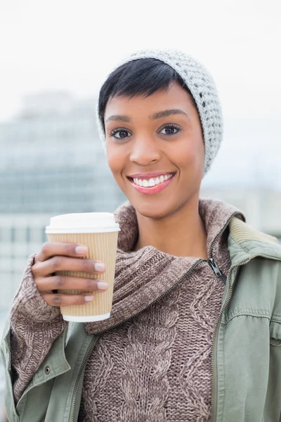 Pretty young model in winter clothes holding a coffee — Stock Photo, Image