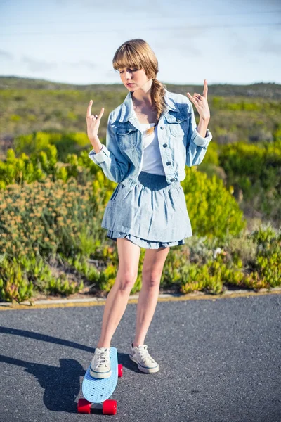 Attractive blonde making rock and roll hand gesture — Stock Photo, Image