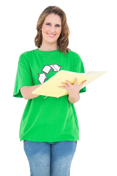 Smiling environmental activist holding notebook looking at camera — Stock Photo, Image