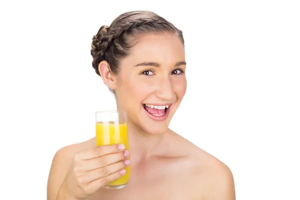 Smiling healthy model holding orange juice — Stock Photo, Image