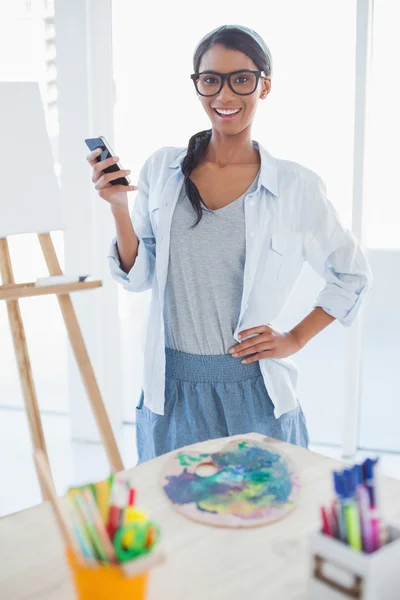 Cheerful pretty artist text messaging — Stock Photo, Image