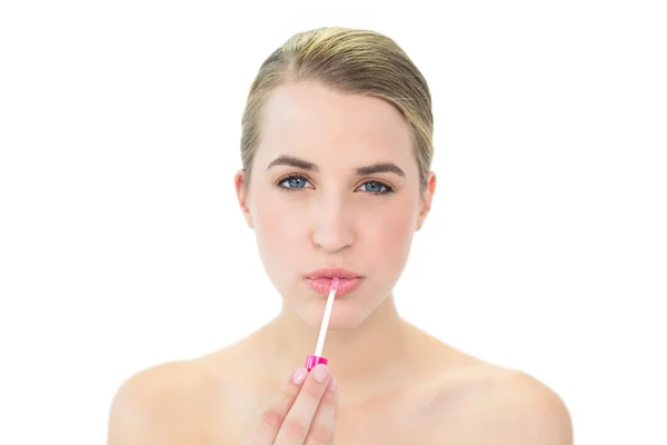 Attractive blonde applying lip gloss — Stock Photo, Image