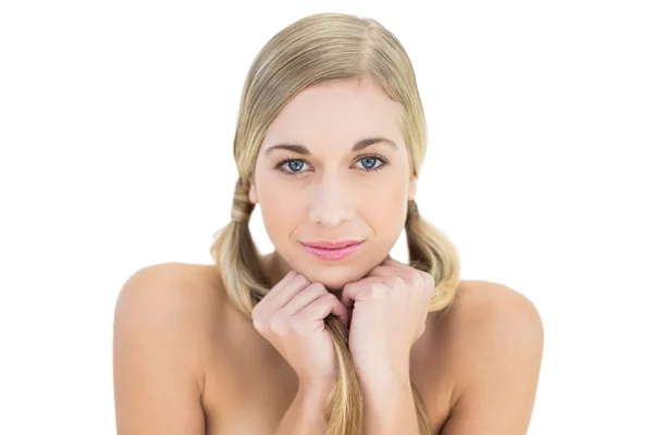 Peaceful young blonde woman holding her pigtails — Stock Photo, Image