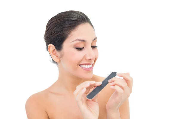 Pretty brunette filling her nails — Stock Photo, Image