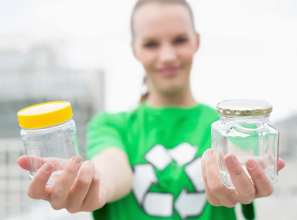 Pleased pretty environmental activist offering two jars — Stock Photo, Image