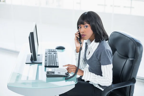 Stern classy businesswoman answering the phone — Stock Photo, Image